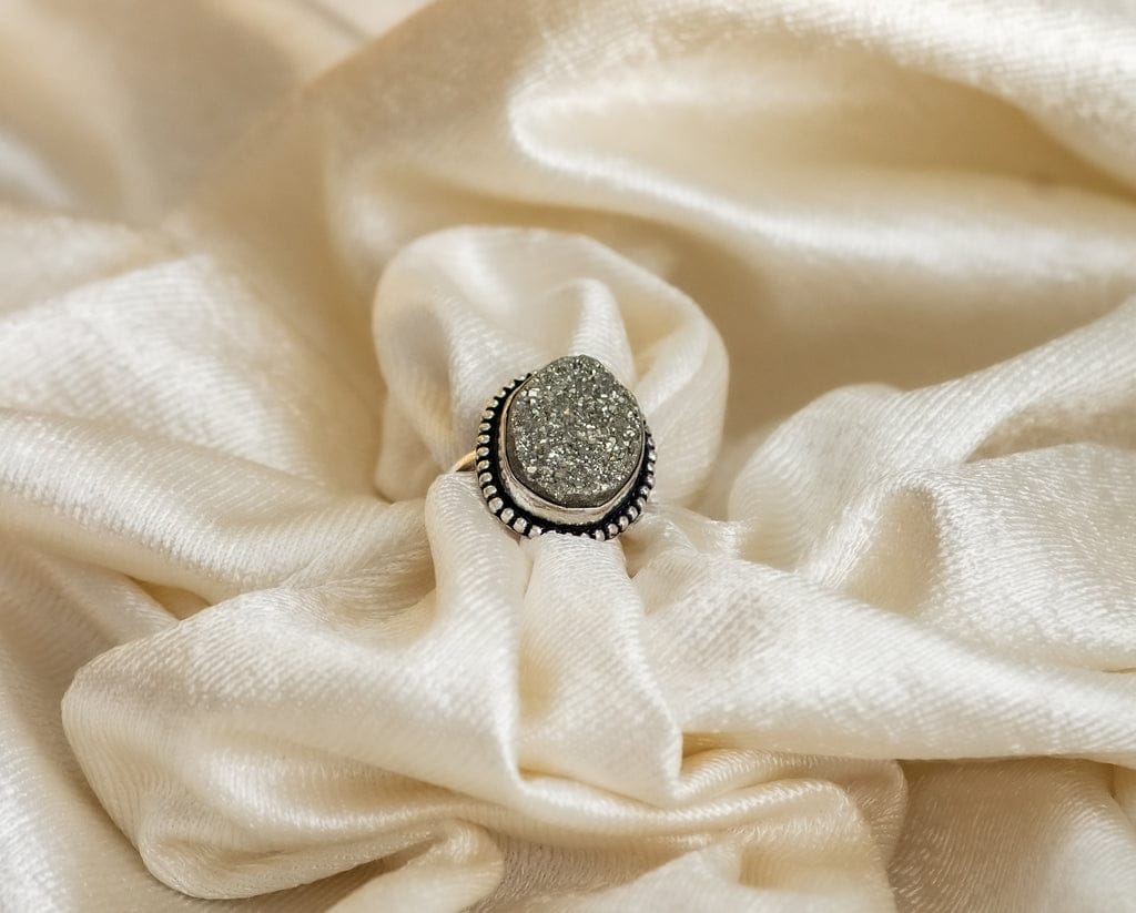 a ring with a large, square-shaped pyrite stone set in a gold-colored mounting.