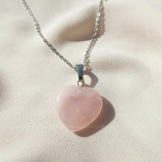 Necklace with a pink Rose Quartz Crystal pendant on a light beige background
