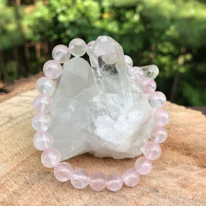 Pink beaded Rose Quartz Bracelet on a large crystal with a natural background