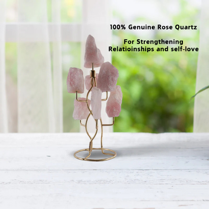 A tree-shaped stand holding raw rose quartz stones.